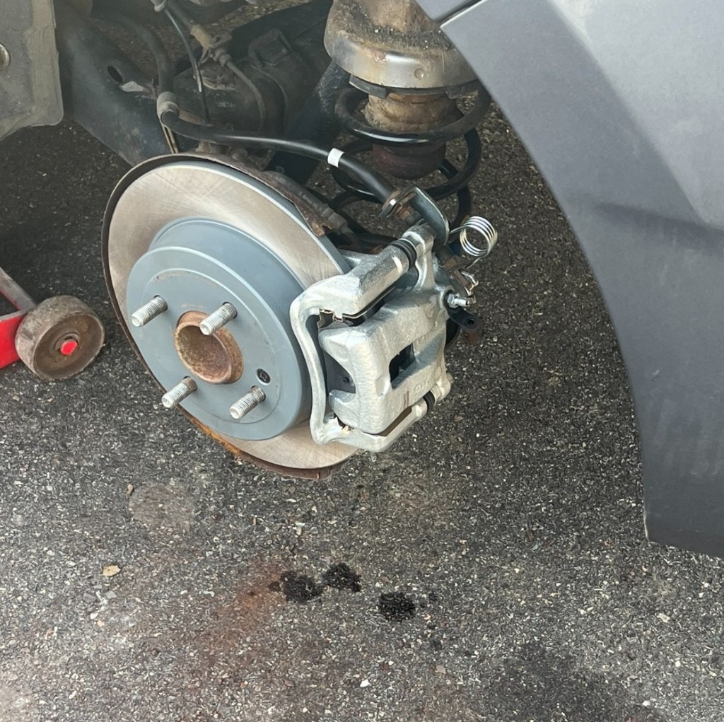 New brake rotor, pads, and caliper on a Hyundai Accent